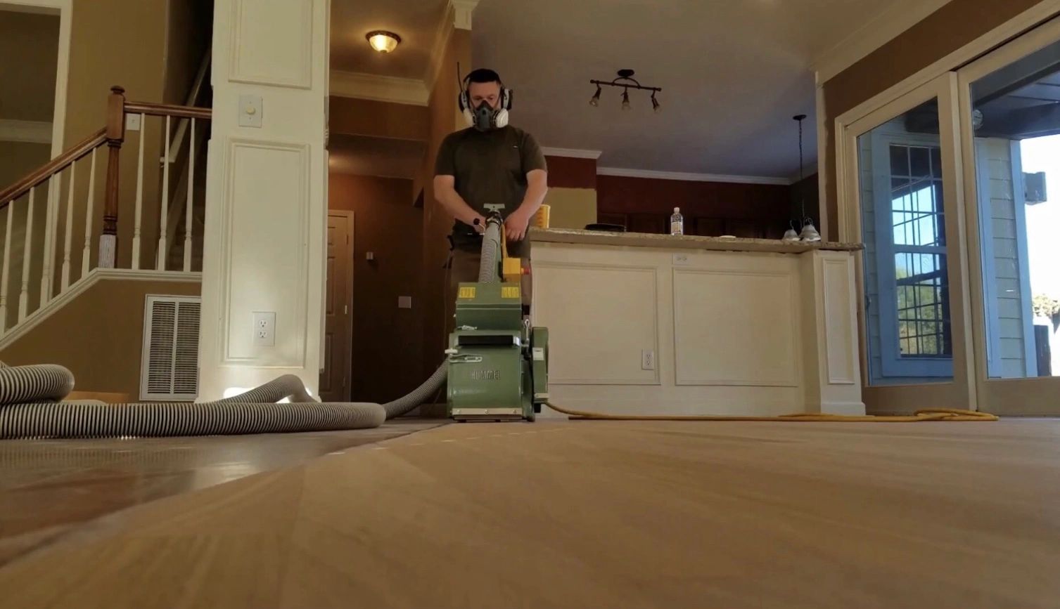 Darin Grimes, owner of Elegant Floors, sanding hardwood floors in Mooresville NC